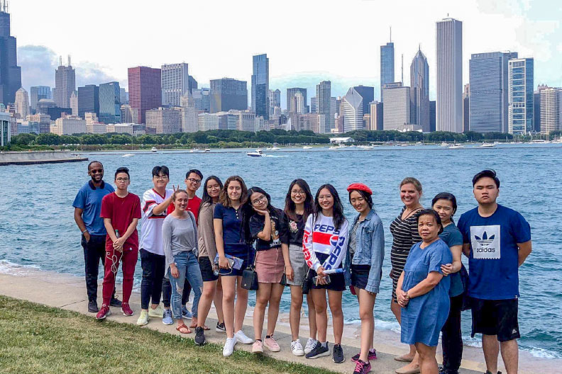 Students participating in Elmhurst College's Collegiate Summer Immersion Program pose in a group photo in front of Lake Michigan in downtown Chicago.