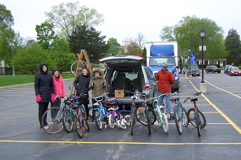 Elmhurst College Recycling Extravaganza participants pose with used bikes donated during last year's event.