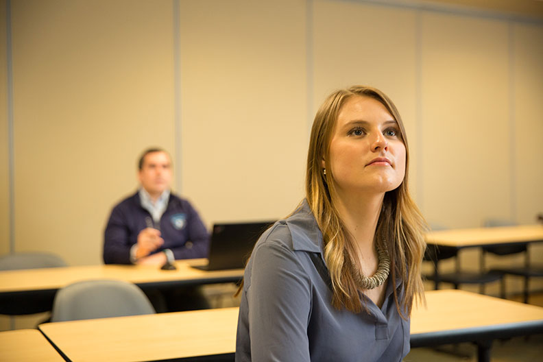 Elmhurst College MBA students Anna Schaefer, front, and Brian Pollastrini participate in their market research practicum class.