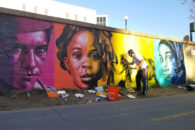 Artist and Elmhurst College faculty member Rafael Blanco is shown painting "Color Isn't Race," his mural in Denver, Colorado.