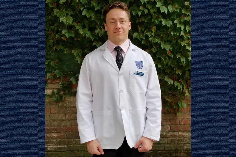 Photo of Elmhurst College student Nicholas Bank getting his white coat at Case Western Reserve University School of Medicine.