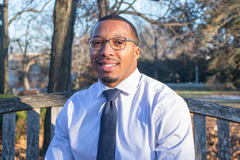 Scottie Williams Jr. sitting on a bench on campus.