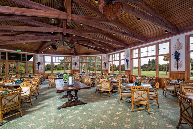 A photo of tables set up inside a dining area in the Hole in the Wall Golf Club in Naples, Florida.