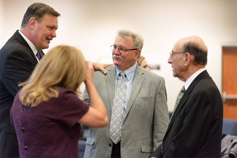 Elmhurst College Professor Mick Savage, center, in gray suit, was honored with the Dr. Andrew K. Prinz Award in October of 2019.