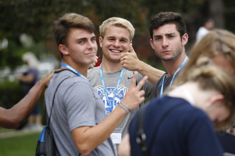 Three male Elmhurst University students give a thumbs-up to the camera during New Student Orientation.