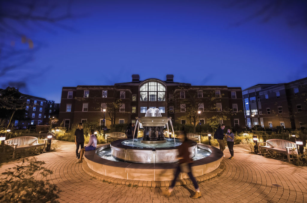 The Alumni Fountain on the Elmhurst University campus is shown at nighttime.