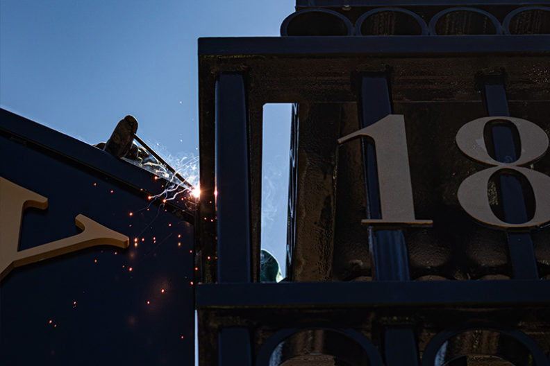 A worker welds a piece of the new Gates of Knowledge on the east end of the Elmhurst University campus in Elmhurst, IL.