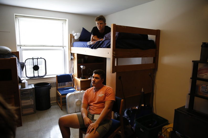 Elmhurst University students try out their bunk beds in their dorm room on move-in day.