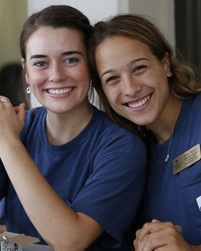 Two smiling female Elmhurst University students.