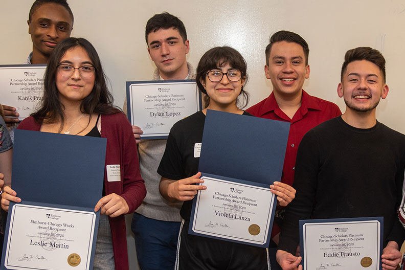 A group of Chicago high school students holding up certificates.