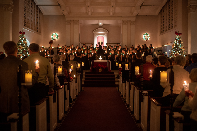 The candlelit aisle to the stage of Hammerschmidt Memorial Chapel, where the Elmhurst University choir performs during the Festival of Lessons and Carols.