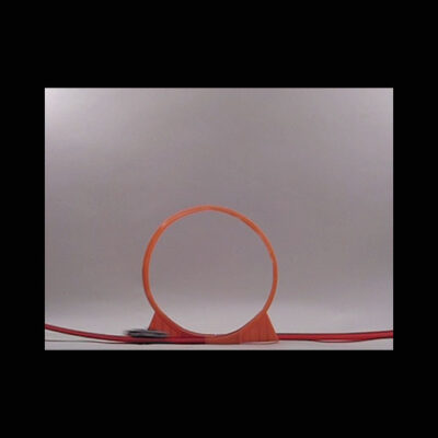 A photo of a looping orange track for a matchbox car.