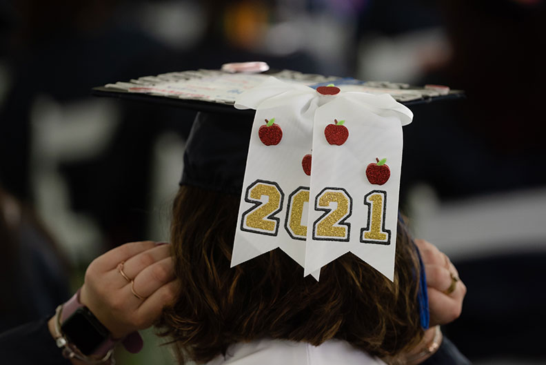 A student's cap reads "2021" at Elmhurst University's 2021 Commencement ceremony.