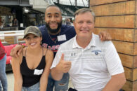 Elmhurst University alumni and University President Troy D. VanAken at a baseball game in Atlanta for the 2021 President's Road Trip.