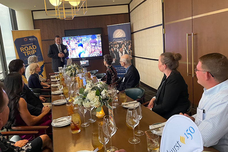 Elmhurst University alumni gather at a dinner table for the 2021 President's Road Trip event in Detroit, MI.