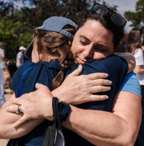 A mother hugs her daughter as they say goodbye during Elmhurst University's New Student Orientation.