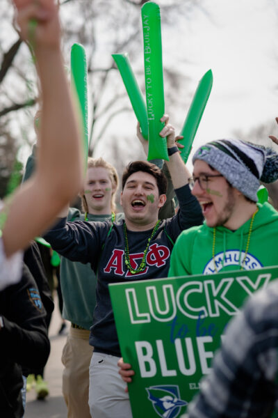 Elmhurst University students march in the 2022 city of Elmhurst St. Patrick's Day parade.