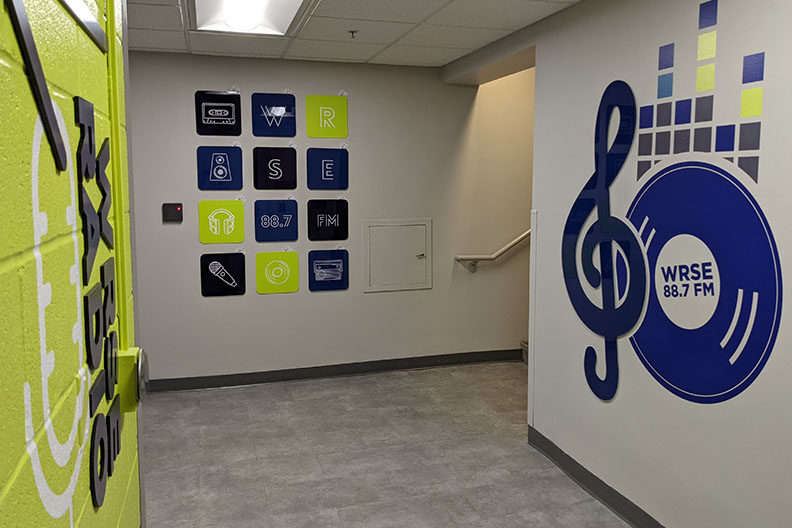 A hallway in Elmhurst University's Frick Center with a mural for the campus radio station, WRSE.