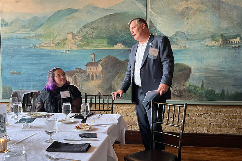 President Troy D. VanAken speaks with a group of Elmhurst University alumni during the 2022 President's Road Trip event in Minneapolis, MN.
