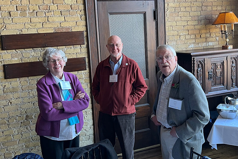 Three Elmhurst University alumni pose for a photo during the 2022 President's Road Trip event in Minneapolis, MN.