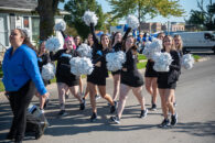 Members of the Elmhurst University Poms team marching in the 2022 Homecoming Parade.