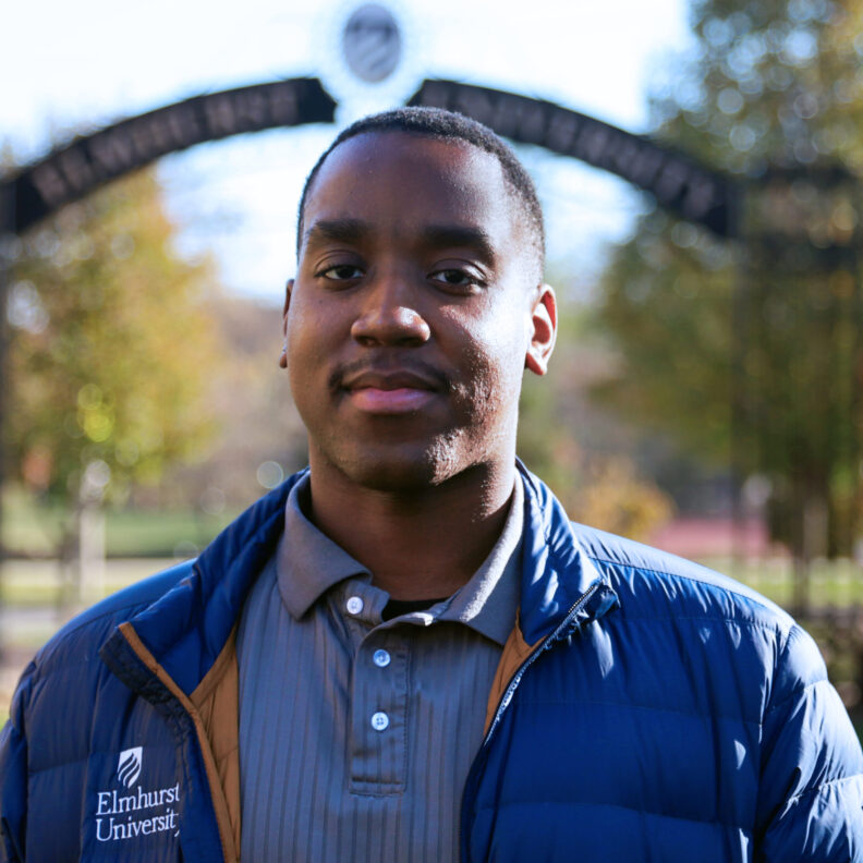 Headshot of Jorden Young-Gentry outside in front of the Gates of Knowledge