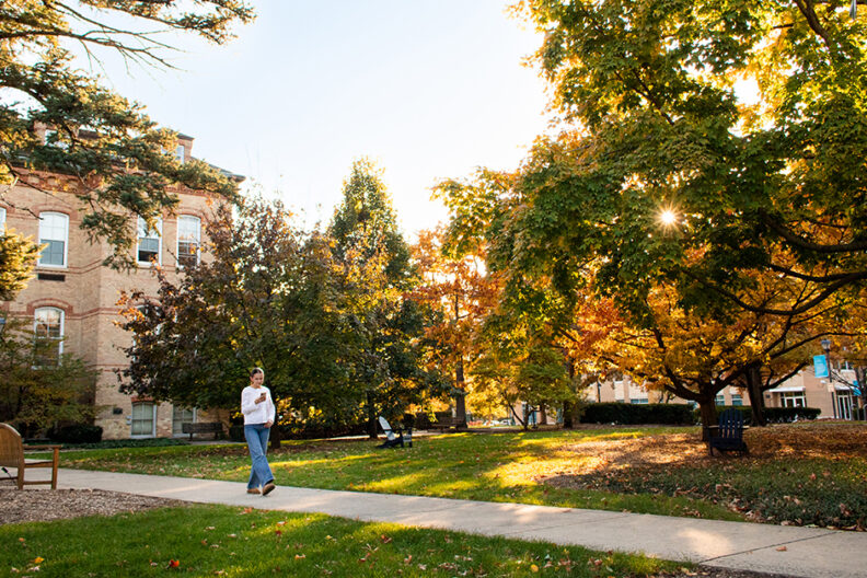 Student walking across the campus