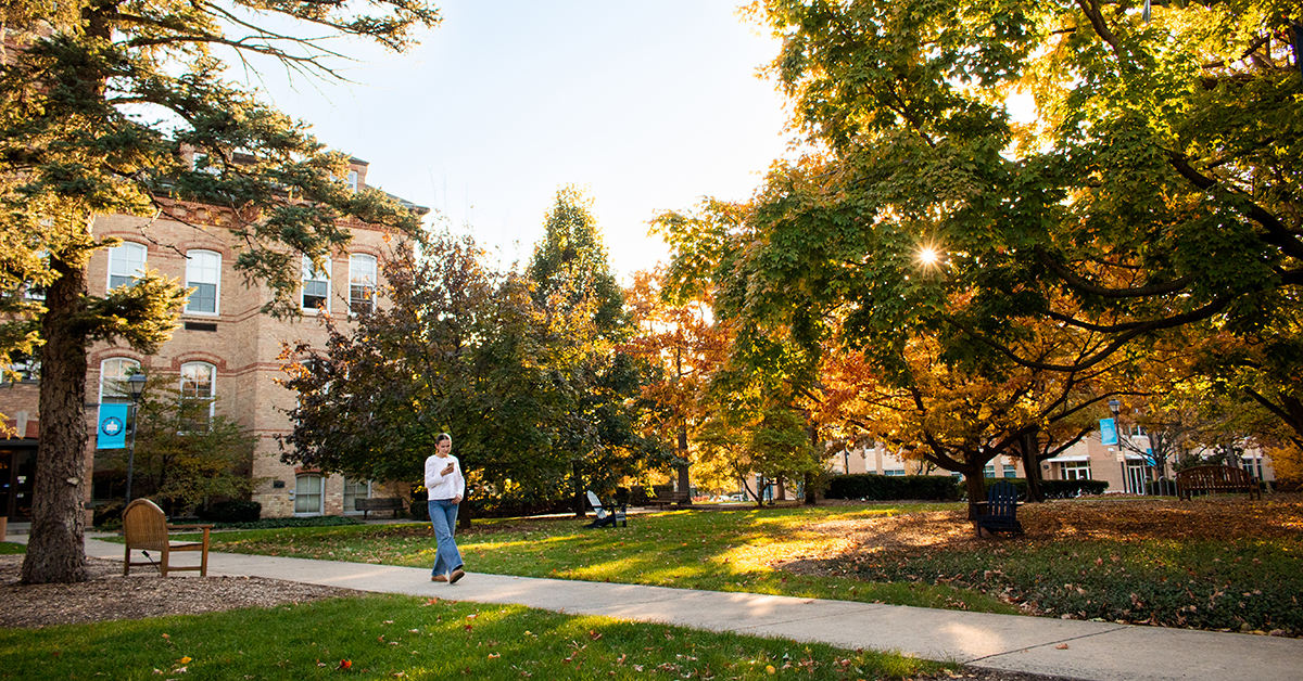Student walking across the campus