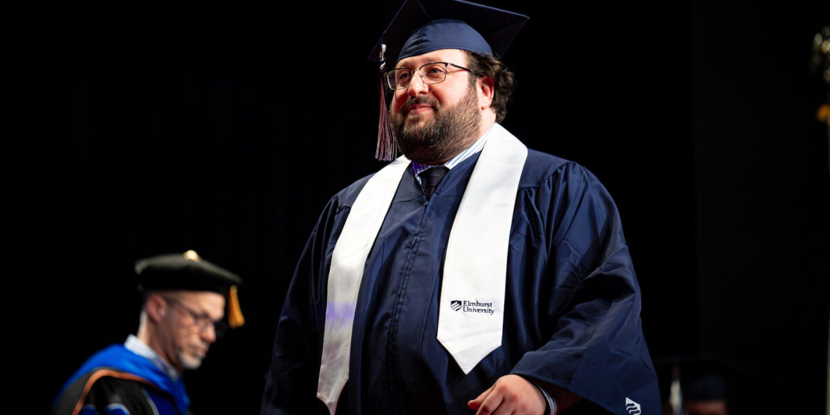 Student walking across the stage at Commencement