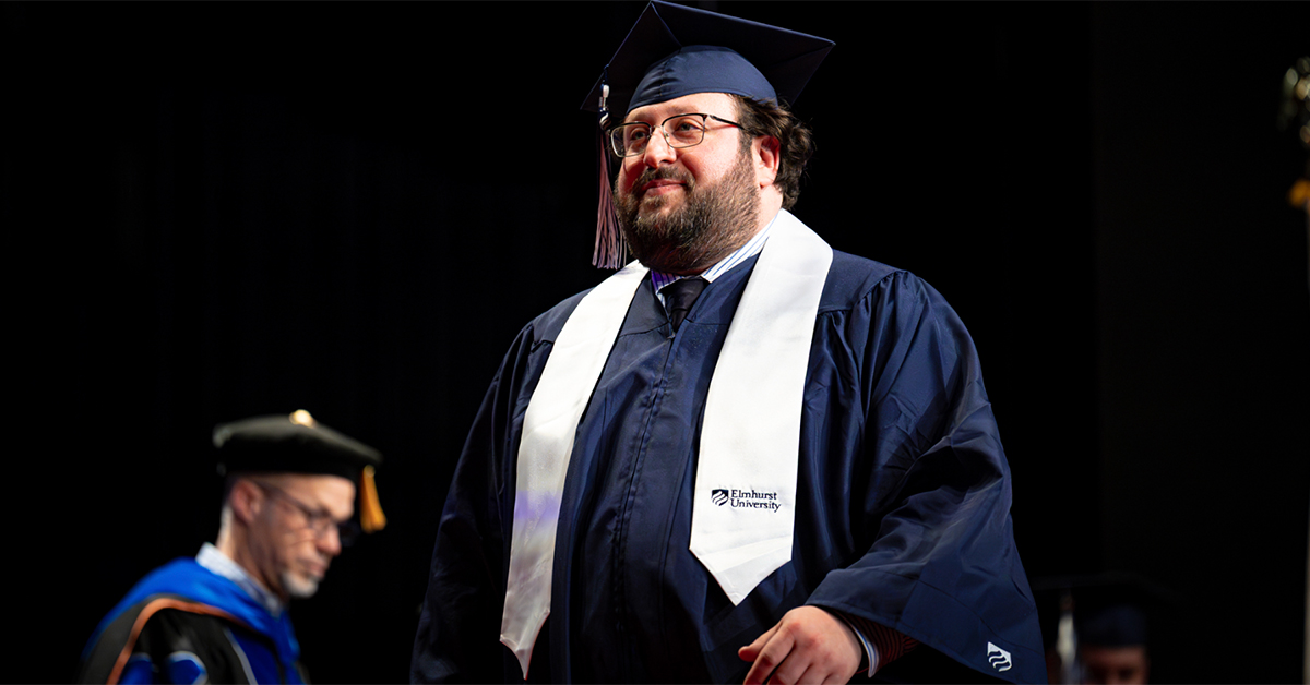 Student walking across the stage at Commencement