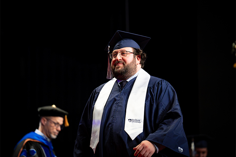 Student walking across the stage at Commencement