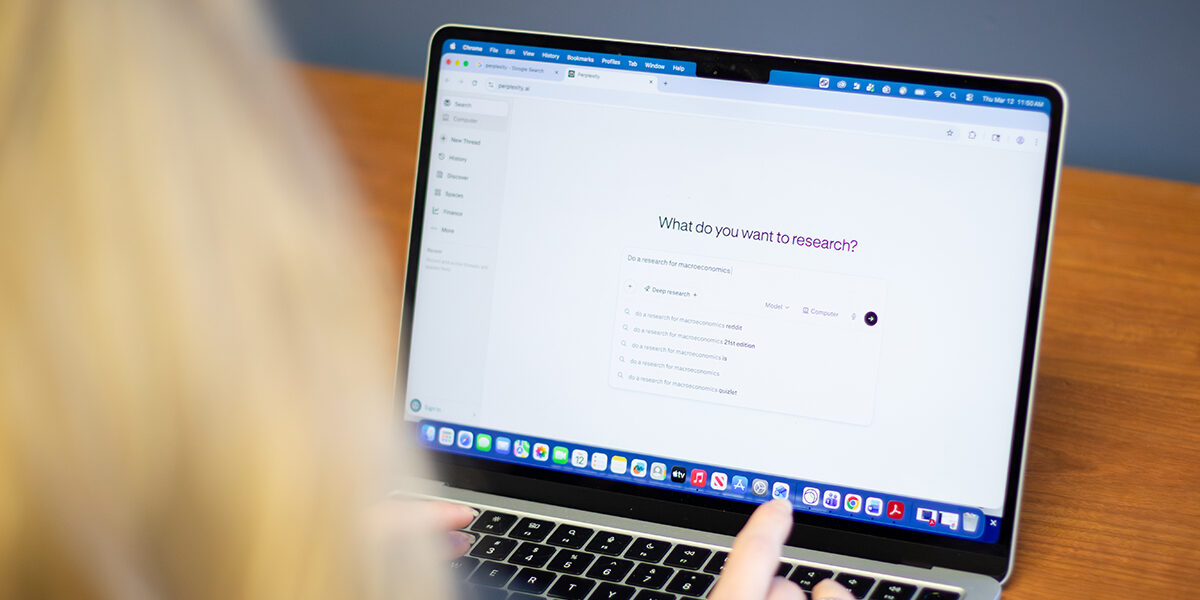 Over the shoulder shot of a student and laptop