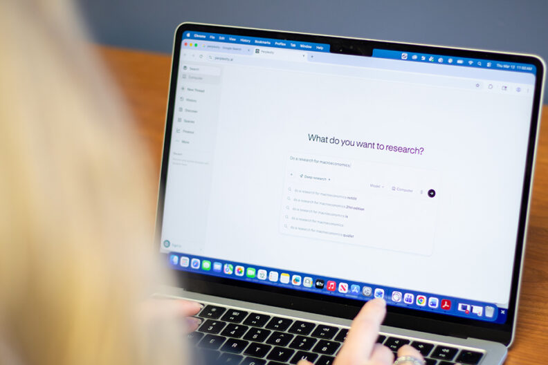 Over the shoulder shot of a student and laptop