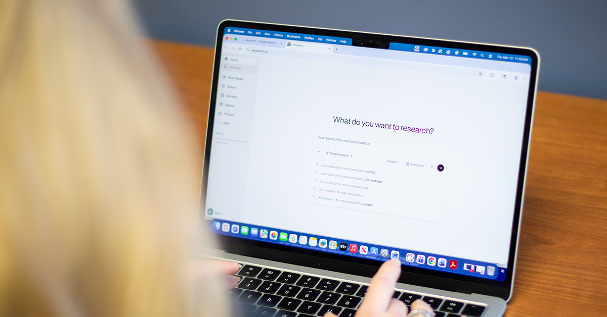 Over the shoulder shot of a student and laptop