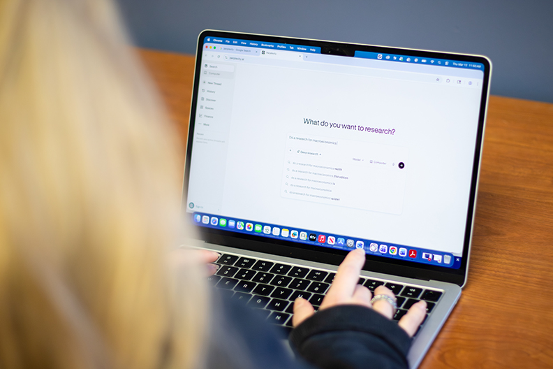 Over the shoulder shot of a student and laptop