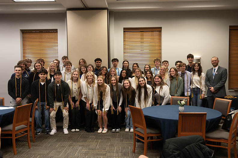 Large group of student athletes posing for a photo