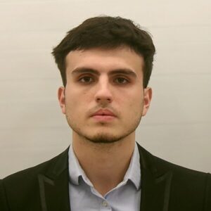 Headshot of Ali Neziri in front of a blank background