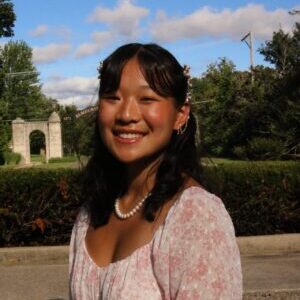 Headshot of Emma Wasilk in front of the Gates of Knowledge