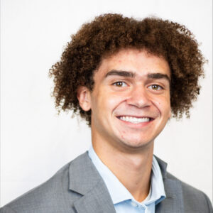 Headshot of John Witcher in front of a blank background