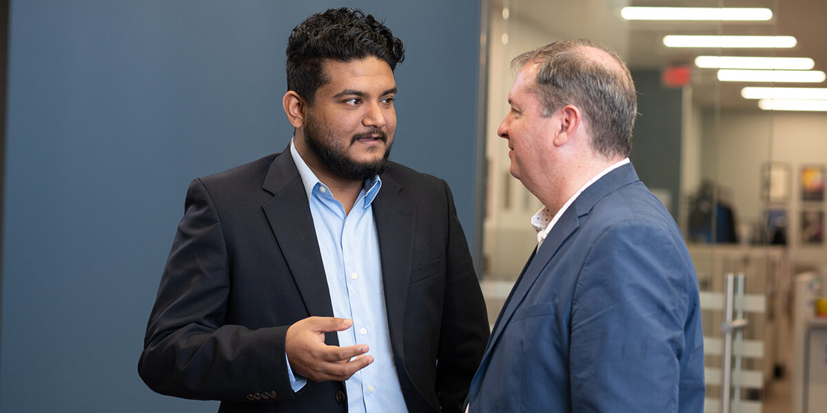 Masters student speaking with instructor