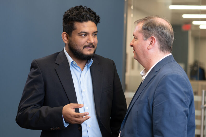 Masters student speaking with instructor