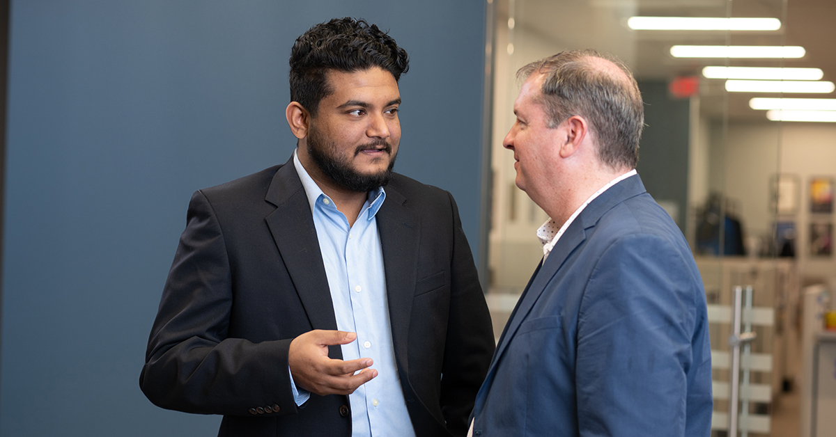 Masters student speaking with instructor