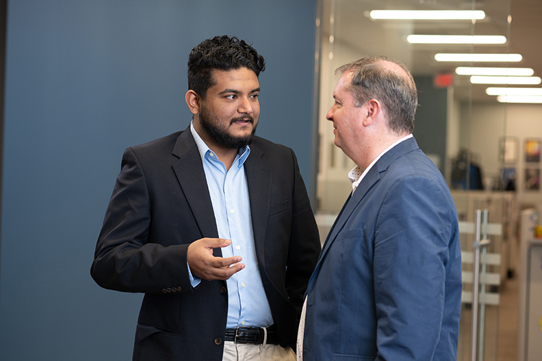 Masters student speaking with instructor