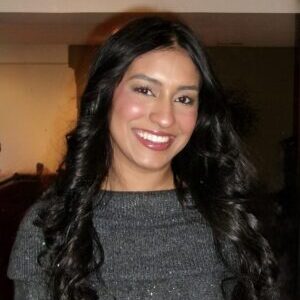 Headshot of Mahek Javed in a dimly lit room