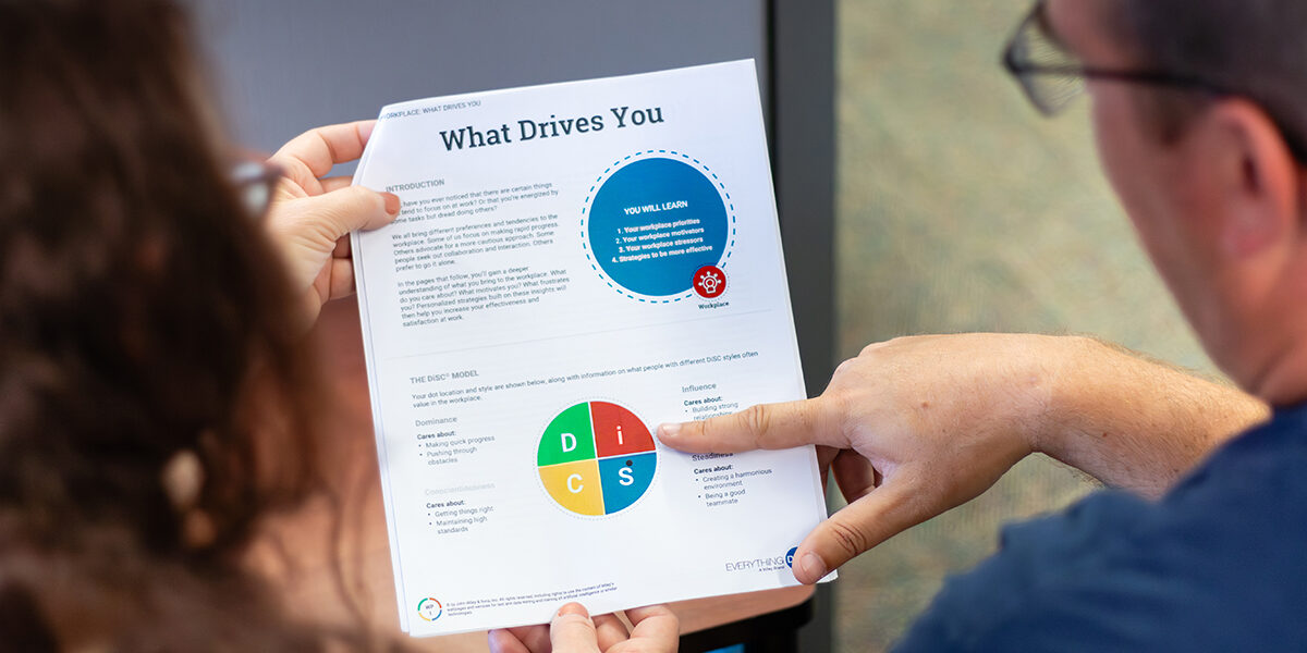Two individuals review a Personality Test together.
